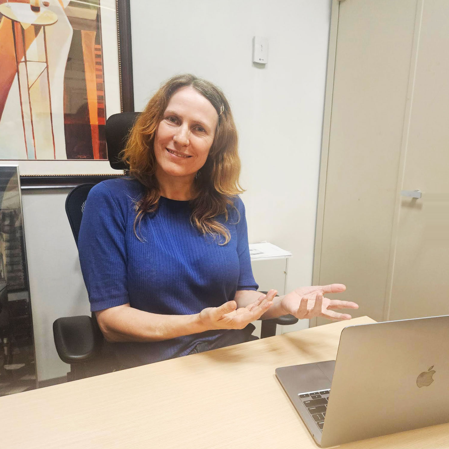 kyra holland in front of a laptop computer